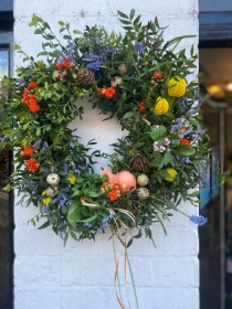 Spring wreath with plants and ceramic chick